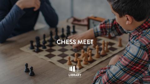 close up of two people playing chess