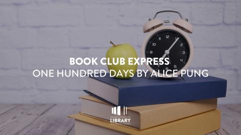 Apple and clock on a stack of books
